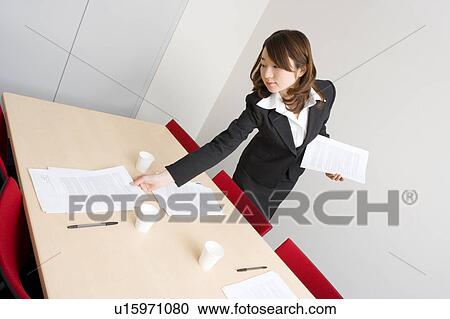 Young businesswoman preparing for meeting View Large Photo Image Stock Image - Young businesswoman preparing for meeting. Fotosearch