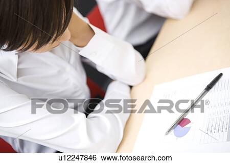 Stock Photograph - Young businesswoman sleeping during meeting. Fotosearch