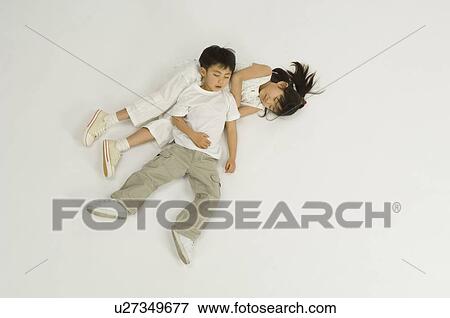 Stock Photo - Children lying on floor. Fotosearch