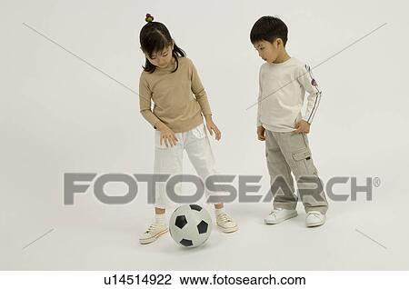 Stock Image - Children playing with soccer ball. Fotosearch