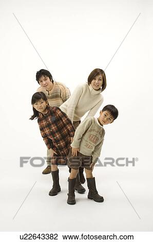 Stock Image - Family looking at camera. Fotosearch