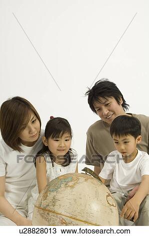 Family looking at globe View Large Photo Image Stock Image - Family looking at globe. Fotosearch