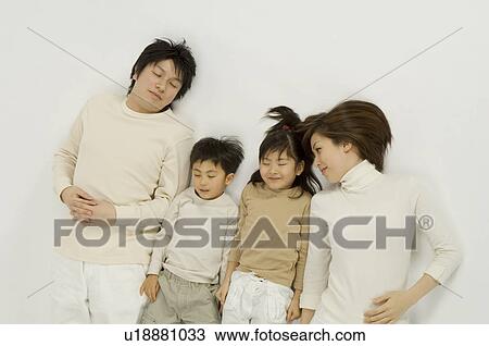 Family lying on floor View Large Photo Image Stock Image - Family lying on floor. Fotosearch