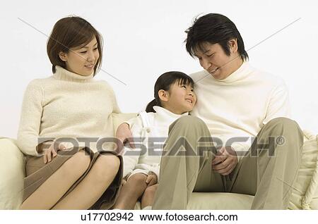 Family sitting on sofa View Large Photo Image Stock Image - Family sitting on sofa. Fotosearch