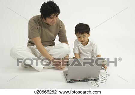 Father and son using computer View Large Photo Image Stock Image - Father and son using computer. Fotosearch