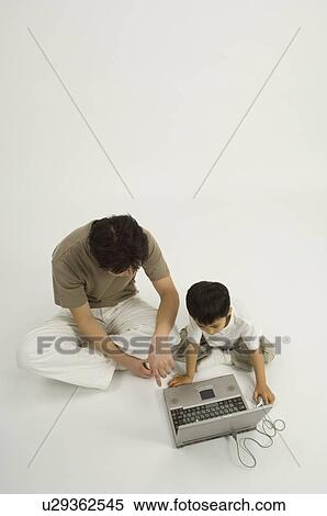 Father and son using computer View Large Photo Image Stock Photography - Father and son using computer. Fotosearch