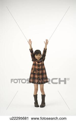 Stock Image - Girl standing with arms outstretched. Fotosearch