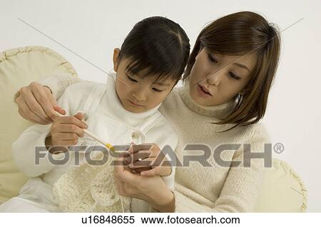 Stock Photography - Mother teaching daughter to knit. Fotosearch