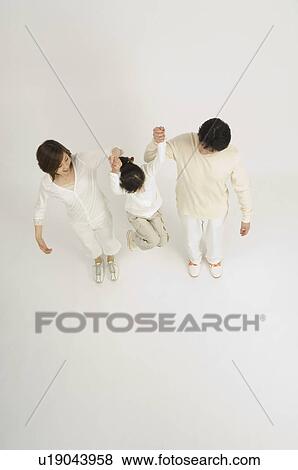 Parents picking up daughter View Large Photo Image Stock Photo - Parents picking up daughter. Fotosearch