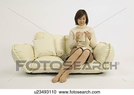 Woman knitting on sofa View Large Photo Image Stock Image - Woman knitting on sofa. Fotosearch