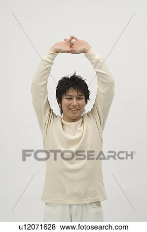 Stock Photo - Young man looking at camera. Fotosearch