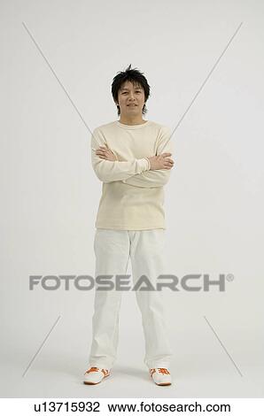 Stock Image - Young man standing. Fotosearch