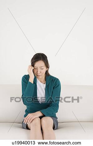 Stock Image - Worried young woman. Fotosearch