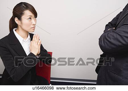Young woman apologizing to her boss View Large Photo Image Stock Photo - Young woman apologizing to her boss. Fotosearch