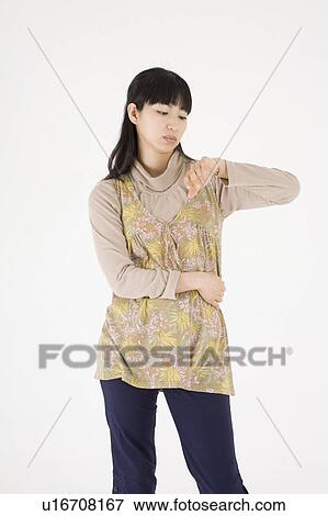 Stock Photo - Young woman checking the time. Fotosearch