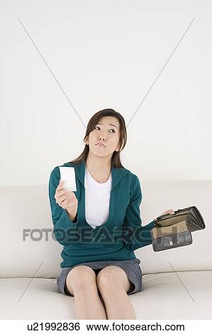 Young woman holding empty wallet View Large Photo Image Stock Photograph - Young woman holding empty wallet. Fotosearch
