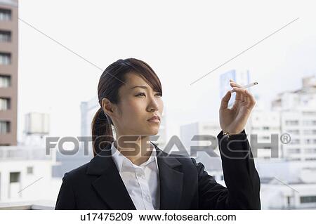 Young woman smoking View Large Photo Image Stock Photo - Young woman smoking. Fotosearch