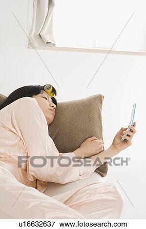 Young woman using mobile phone View Large Photo Image Stock Photo - Young woman using mobile phone. Fotosearch