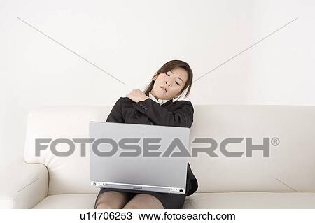 Young woman working on computer View Large Photo Image Stock Image - Young woman working on computer. Fotosearch
