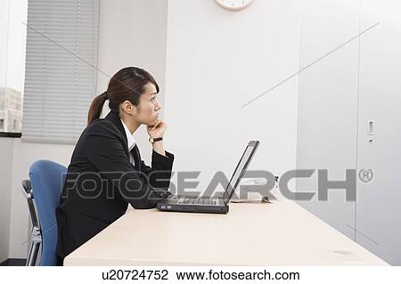 Young woman working on computer View Large Photo Image Stock Image - Young woman working on computer. Fotosearch