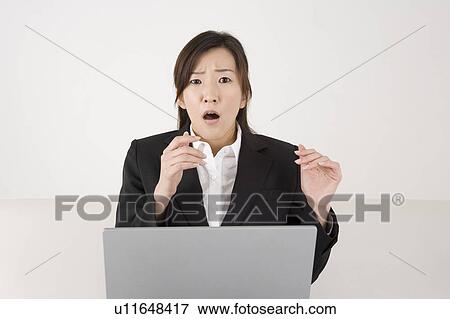 Stock Photo - Young woman working on computer. Fotosearch