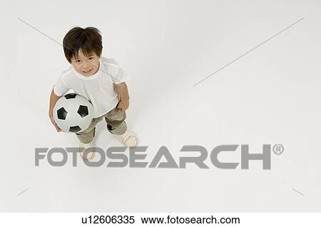 Elementary age boy holding soccer ball View Large Photo Image Stock Photography - Elementary age boy holding soccer ball. Fotosearch
