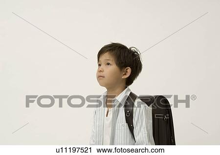 Elementary age boy looking up View Large Photo Image Stock Image - Elementary age boy looking up. Fotosearch