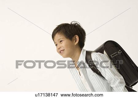 Stock Photo - Elementary age boy looking up. Fotosearch