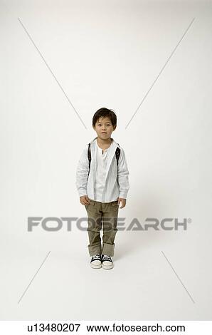 Stock Photo - Elementary age boy standing. Fotosearch