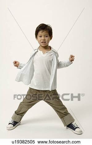 Stock Photography - Elementary age boy standing. Fotosearch
