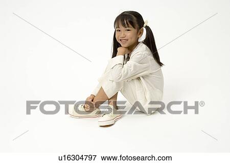 Stock Photo - Elementary age girl sitting. Fotosearch