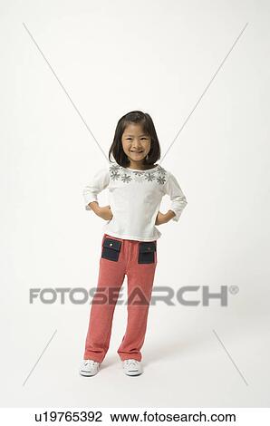Stock Image - Elementary age girl standing. Fotosearch