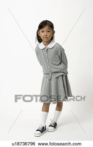Stock Photograph - Elementary age girl standing. Fotosearch