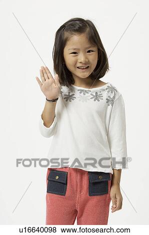 Stock Photo - Elementary age girl waving. Fotosearch