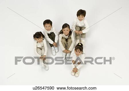 Stock Image - Five elementary age children sitting. Fotosearch