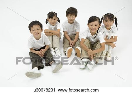 Stock Image - Five elementary age children sitting. Fotosearch