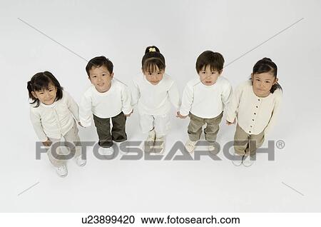 Stock Image - Five elementary age children standing. Fotosearch
