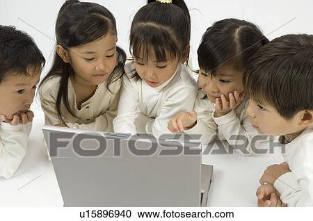 Five elementary age children using laptop View Large Photo Image Stock Image - Five elementary age children using laptop. Fotosearch