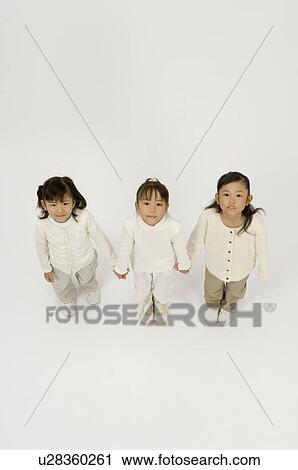 Three elementary age girls standing View Large Photo Image Stock Image - Three elementary age girls standing. Fotosearch