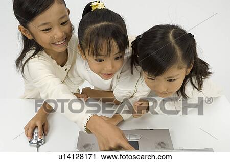 Three elementary age girls using laptop View Large Photo Image Stock Image - Three elementary age girls using laptop. Fotosearch