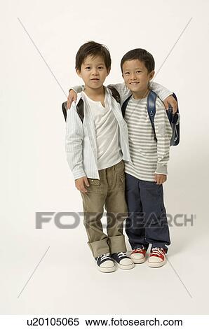 Two elementary age boys looking at camera View Large Photo Image Stock Photography - Two elementary age boys looking at camera. Fotosearch