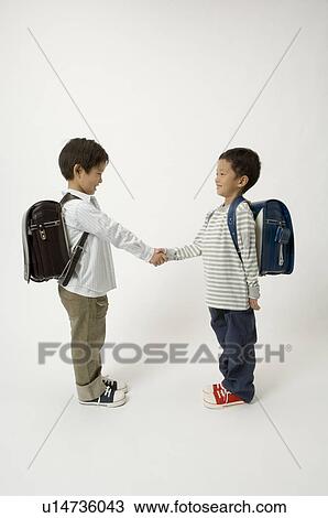 Two elementary age boys shaking hands View Large Photo Image Stock Image - Two elementary age boys shaking hands. Fotosearch