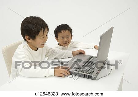 Two elementary age boys using laptop View Large Photo Image Stock Image - Two elementary age boys using laptop. Fotosearch