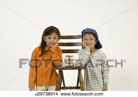 Two elementary age children standing View Large Photo Image Picture - Two elementary age children standing. Fotosearch