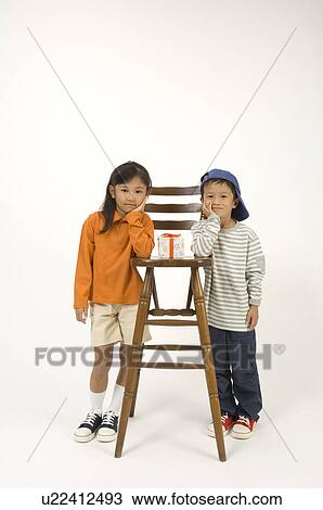 Two elementary age children standing View Large Photo Image Stock Image - Two elementary age children standing. Fotosearch