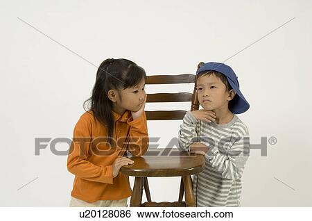 Stock Photograph - Two elementary age children standing. Fotosearch