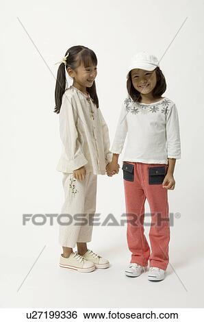 Two elementary age girls holding hands View Large Photo Image Stock Photograph - Two elementary age girls holding hands. Fotosearch