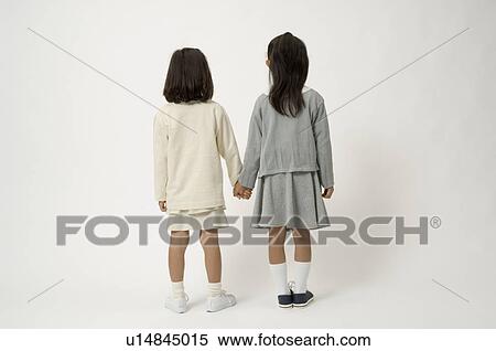Two elementary age girls standing, rear view View Large Photo Image Stock Photography - Two elementary age girls standing, rear view. Fotosearch
