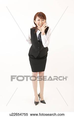 Stock Photography - A woman in formal attire calling somebody. Fotosearch