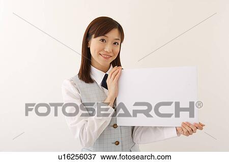 A woman in formal attire holding a white blank message View Large Photo Image Stock Photo - A woman in formal attire holding a white blank message. Fotosearch